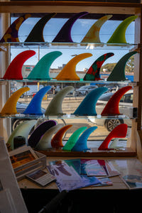 Pemulis store interior — surfboards, fins, and vintage moto gear